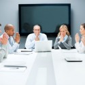 Group of businesspeople pray on a meeting.